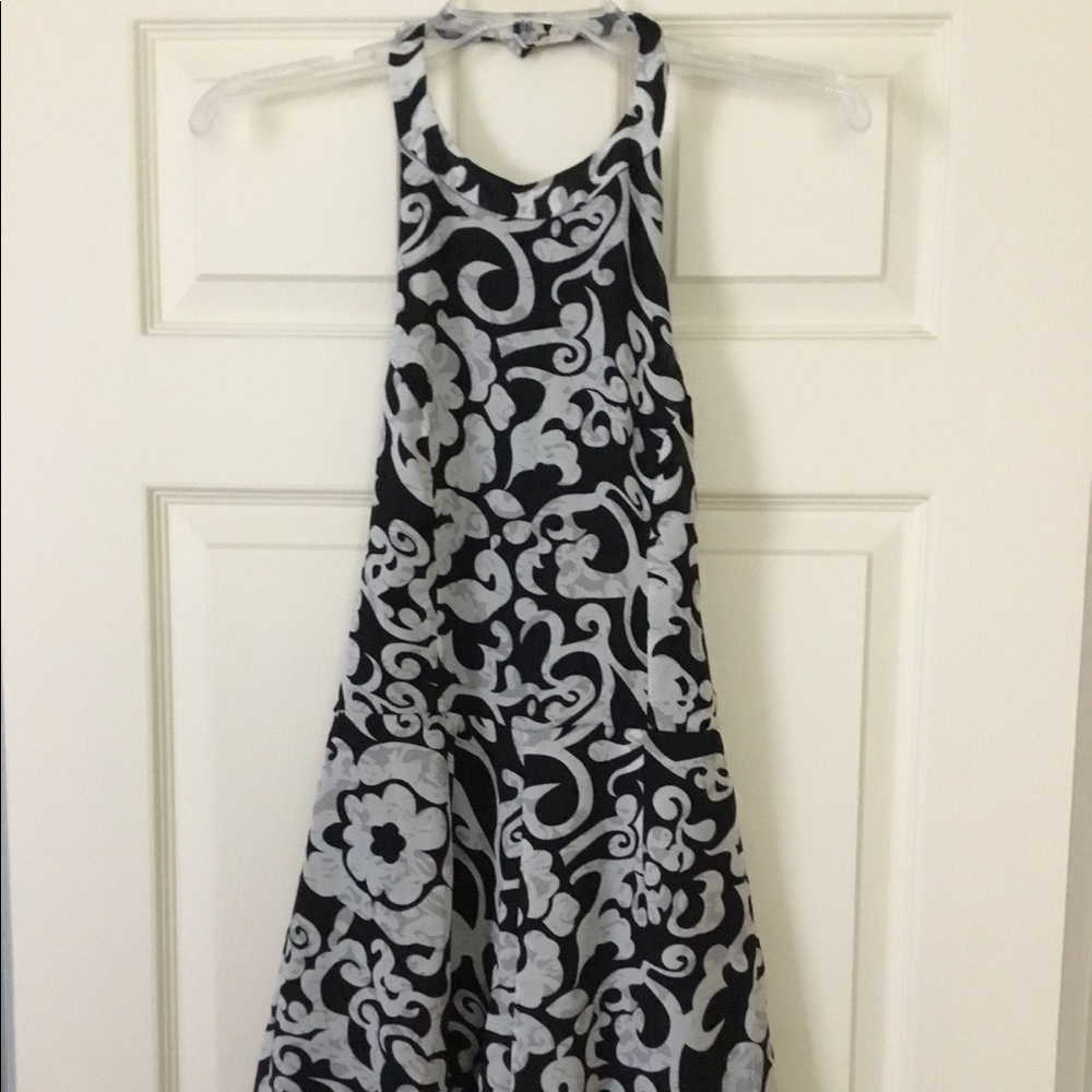 Black and cream colored halter, backless romper